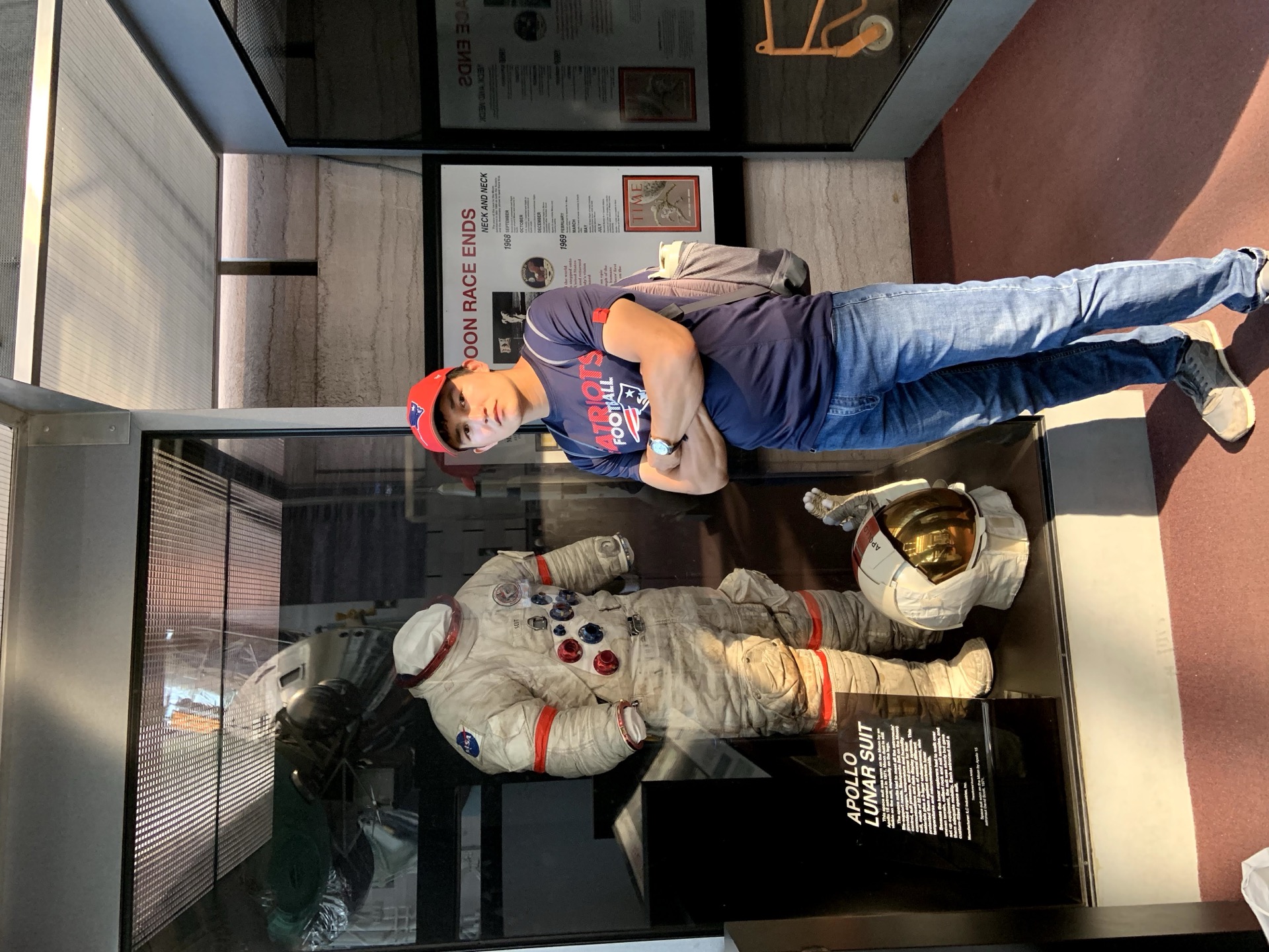 Khurshid Normurodov beside an Apollo lunar spacesuit exhibit at a space museum