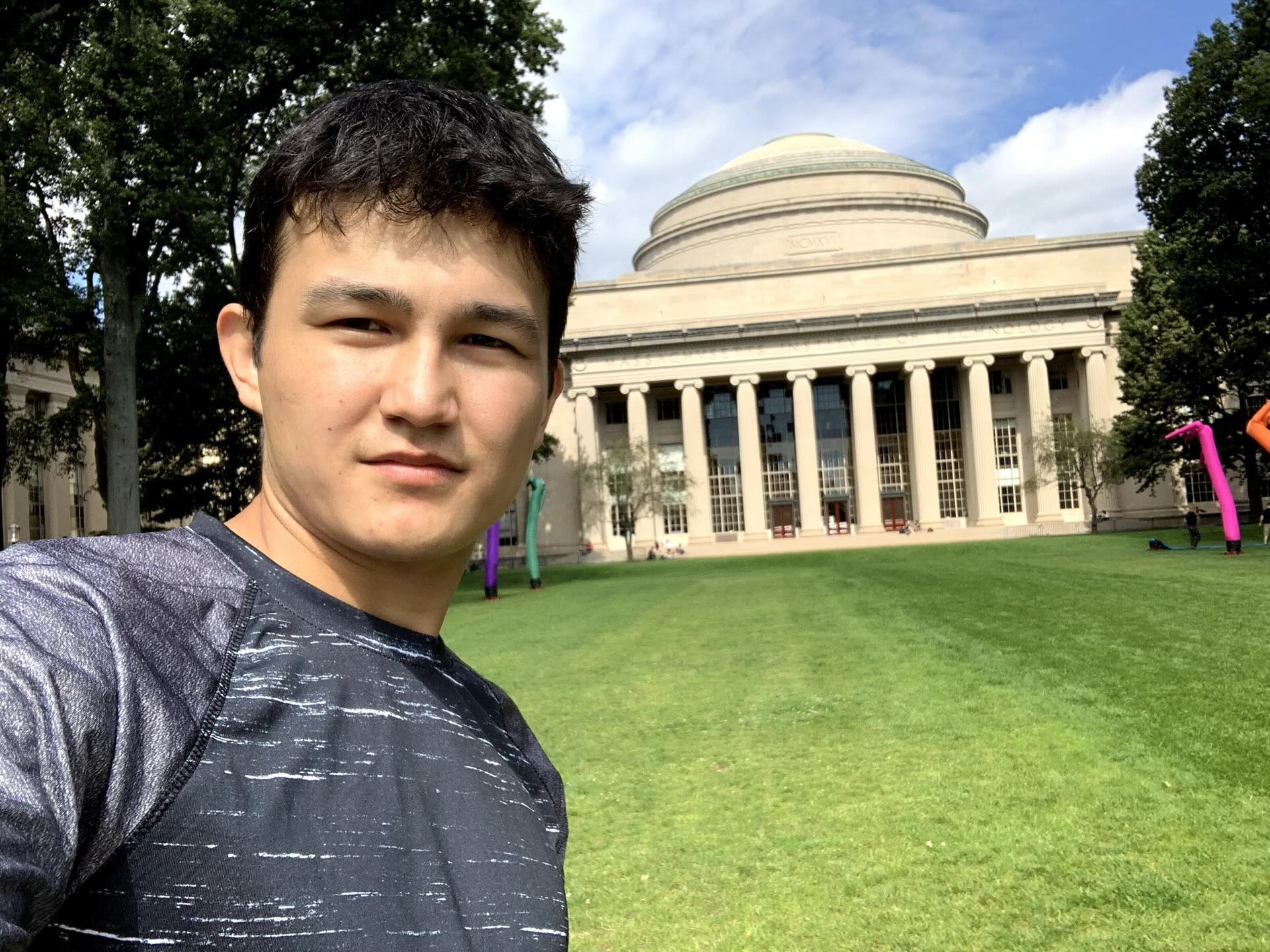 Khurshid Normurodov on the MIT campus lawn in front of the Great Dome