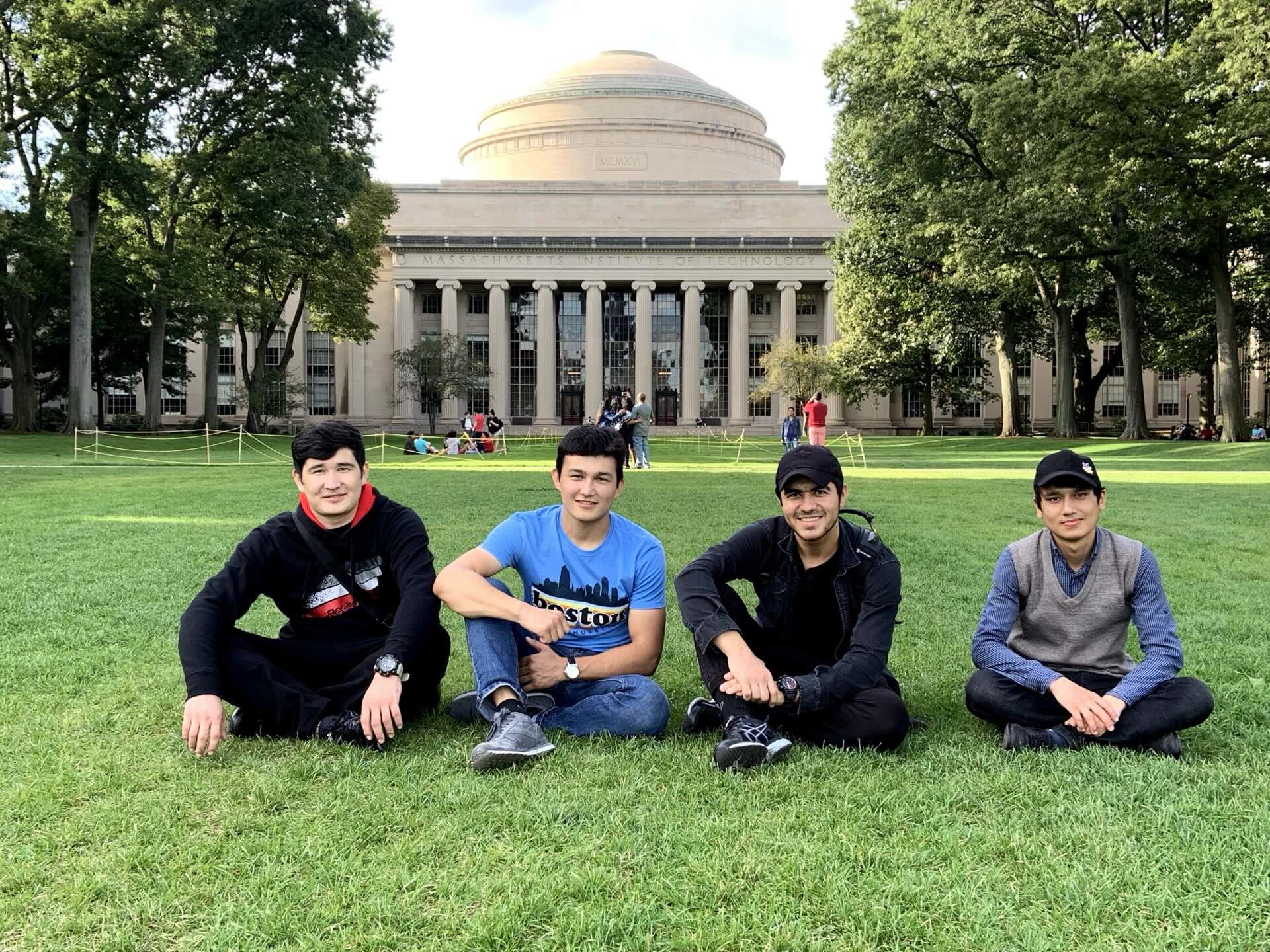 Khurshid Normurodov with friends on the lawn in front of MIT's Great Dome