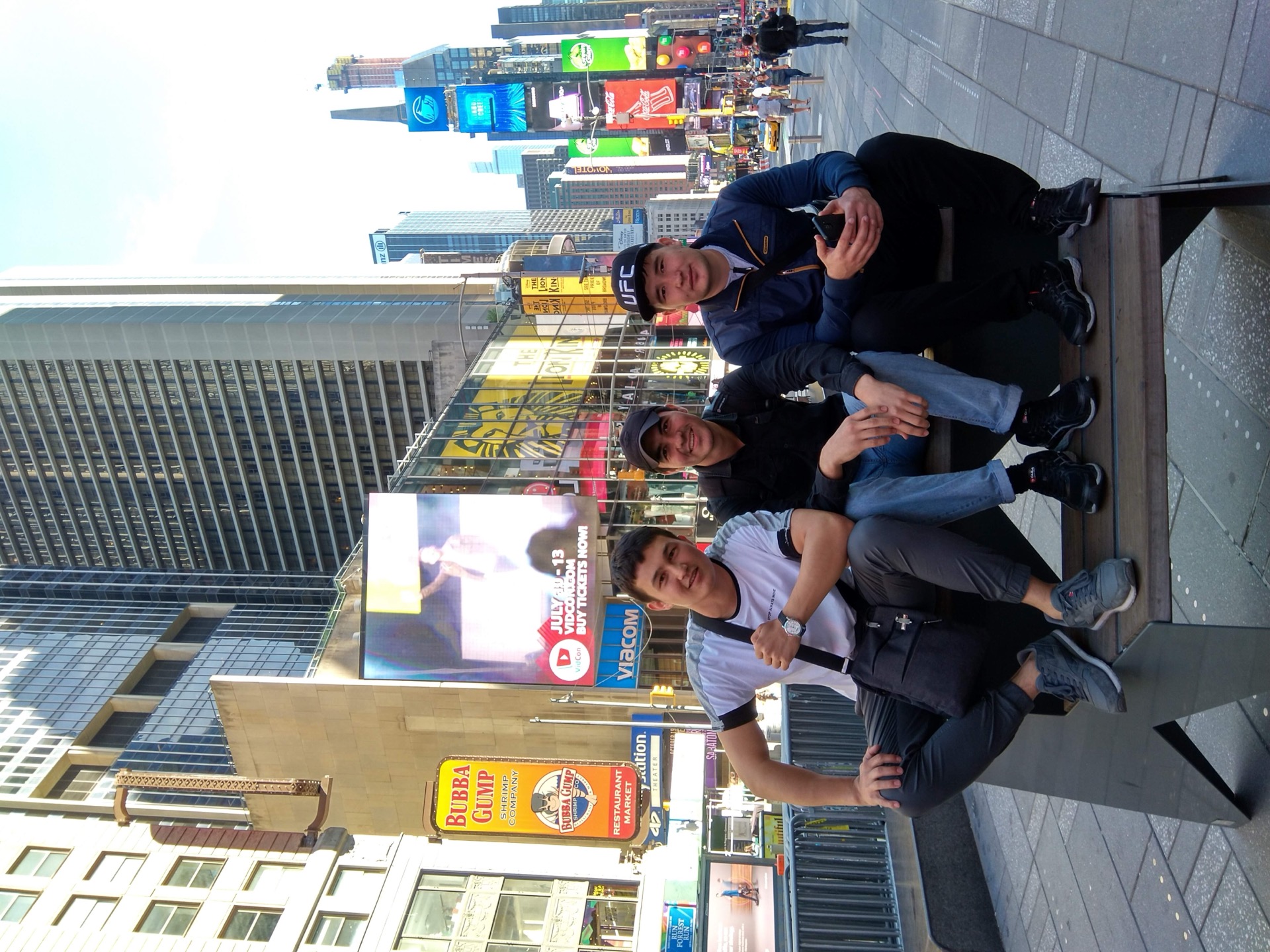 Khurshid Normurodov with friends in Times Square, New York