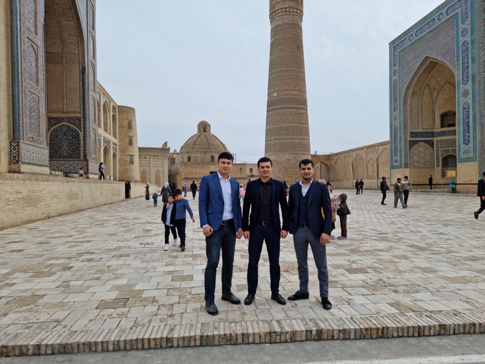 Khurshid Normurodov with colleagues at a historic site in Bukhara, Uzbekistan