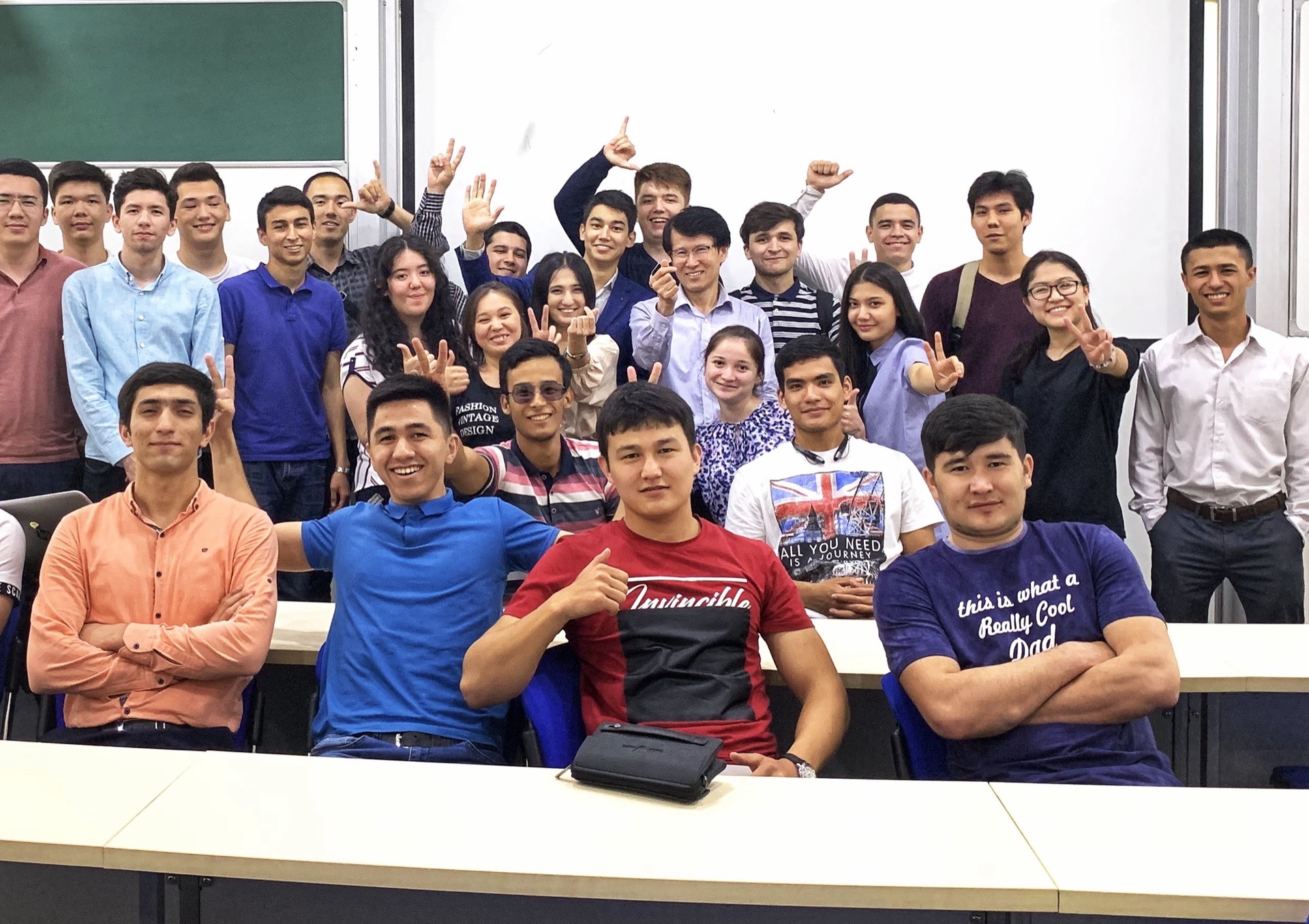 Khurshid Normurodov with INHA University classmates in a lecture hall